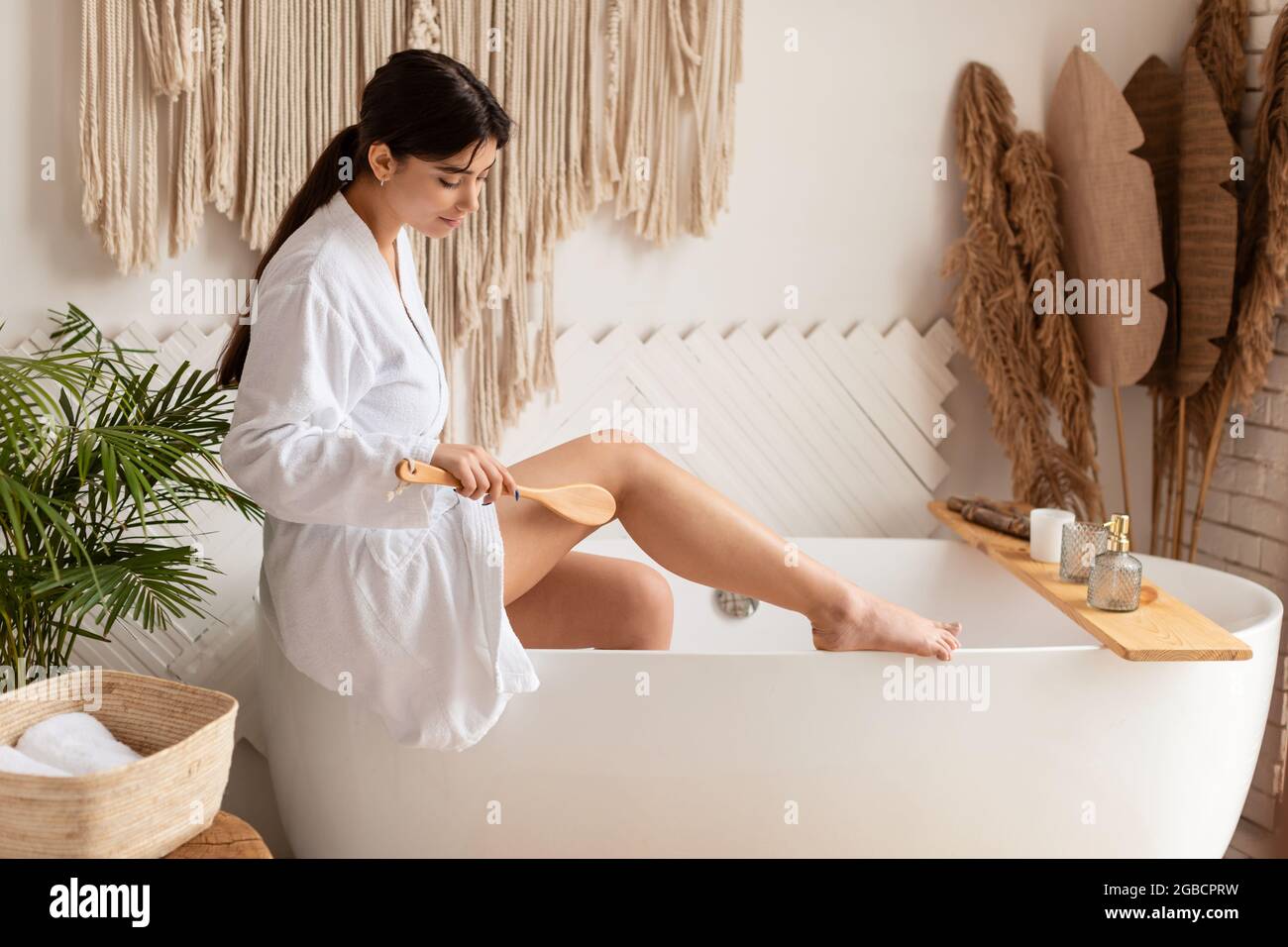 Lady spazzolatura a secco gambe fare massaggio per la prevenzione delle  cellulite indoor Foto stock - Alamy
