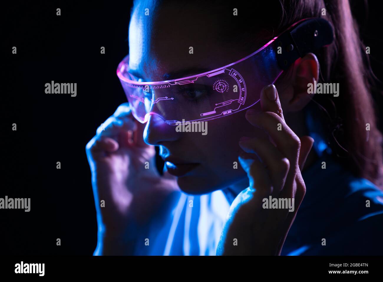 Ritratto di una giovane donna che usa occhiali digitali futuristici Foto Stock