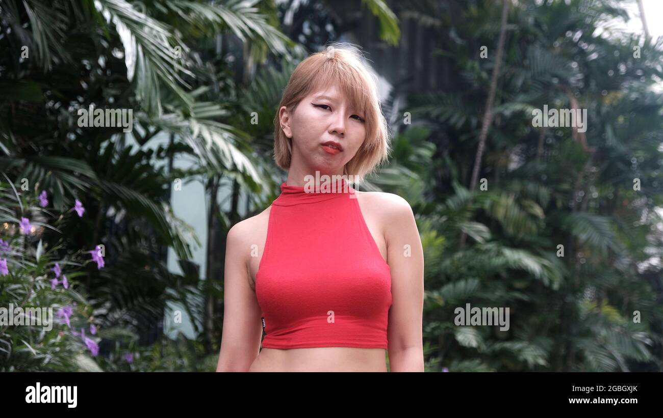 Modello giapponese Young Lady Asian che indossa un vestito rosso a Bangkok tropicale Foto Stock