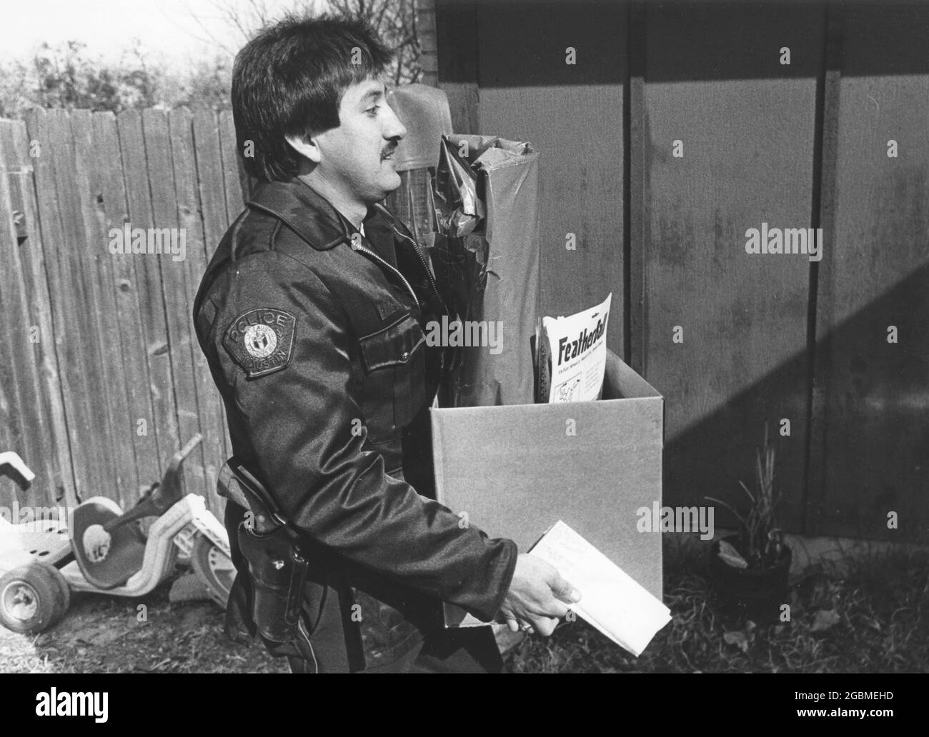 Austin Texas USA, circa 1990: Il volontario consegna scatola di regali di Natale alla famiglia a basso reddito attraverso il programma annuale Blue Santa del Dipartimento di polizia di Austin. ©Bob Daemmrich Foto Stock
