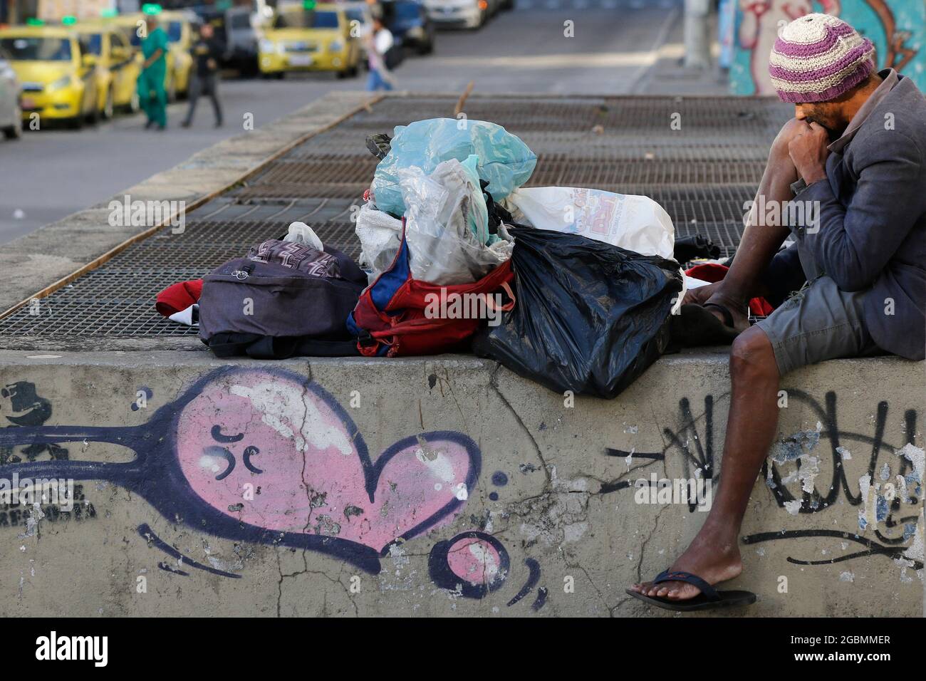 Uomo senza casa, mendicante vivere su un marciapiede durante la crisi economica in centro, in cerca di aiuto, affamato. Povertà situazione vulnerabile, problemi sociali in lat Foto Stock
