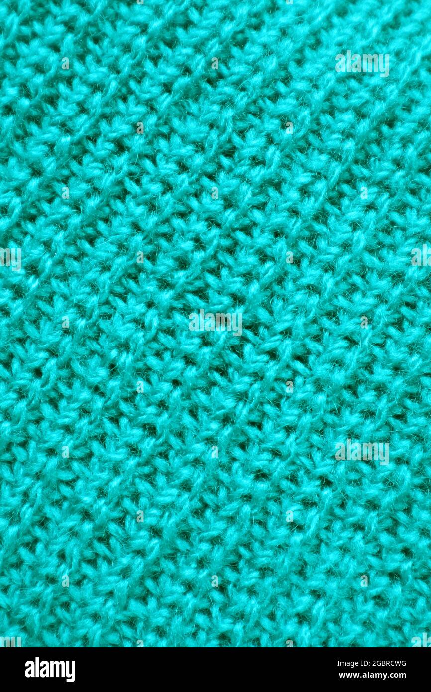 Closeup la texture di Turquoise Blue tessuto a maglia in lana con motivi diagonali Foto Stock