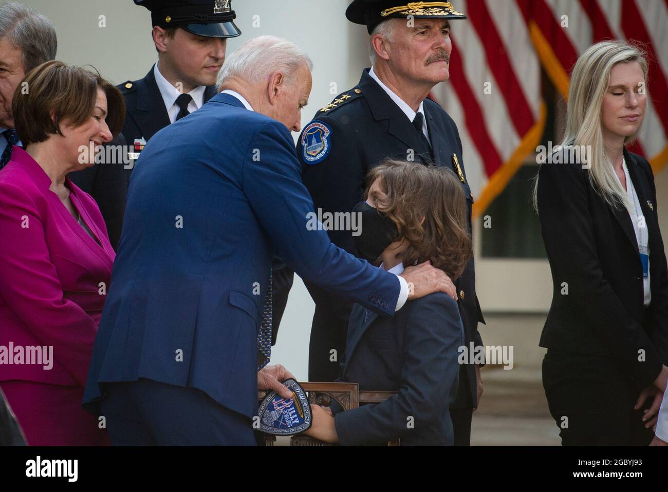 Il presidente degli Stati Uniti Joe Biden comforts Logan Evans, figlio dell'ufficiale della polizia del Campidoglio ucciso William "Billy" Evans, dopo aver firmato H.R. 3325, "un atto per assegnare quattro medaglie d'oro del Congresso alla polizia del Campidoglio degli Stati Uniti e a coloro che hanno protetto il Campidoglio degli Stati Uniti il 6 gennaio, 2021," in legge nel Rose Garden della Casa Bianca a Washington, DC, giovedì 5 agosto 2021. Credito: Rod Lamkey/CNP/MediaPunch Foto Stock