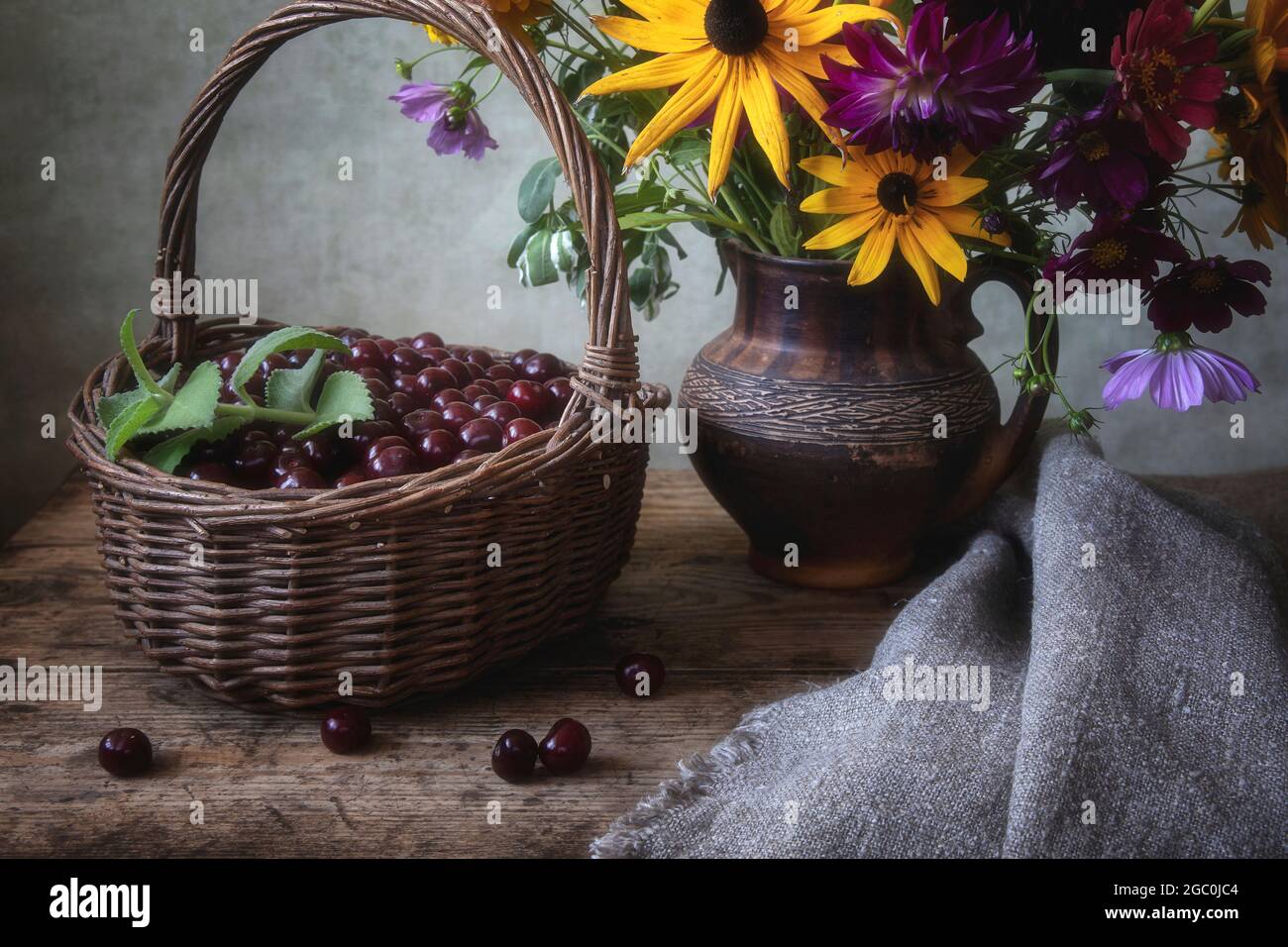 Ancora vita con ciliegia e bouquet di fiori da giardino Foto Stock