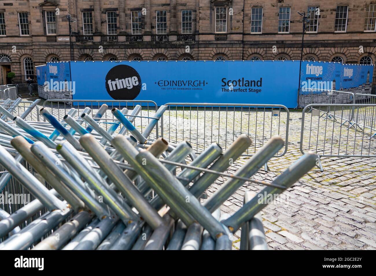 Edimburgo, Scozia, Regno Unito. 6 agosto 2021. Immagini dal Royal Mile nella città vecchia di Edimburgo il giorno di apertura del Festival della frangia di Edimburgo 2021. Il festival sembra molto diverso da due anni fa . Sono consentiti pochissimi spazi per spettacoli di strada e sono evidenti meno turisti. Anche un'elevata visibilità della polizia, ci sono più agenti di polizia che artisti per strada, è in netto contrasto con gli anni precedenti. PIC; parte posteriore dello spazio di prestazioni schermato con molte barriere. Iain Masterton/Alamy Notizie dal vivo. Foto Stock