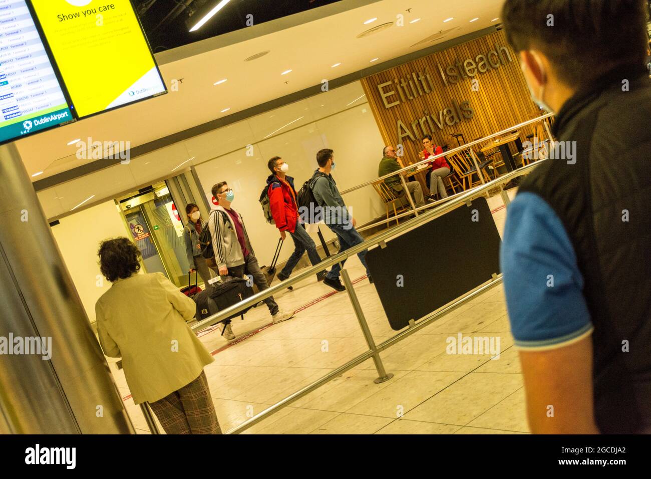 I passeggeri che indossano maschere arrivano all'aeroporto di Dublino, terminal 1, durante la pandemia di Covid19, Irlanda. Foto Stock