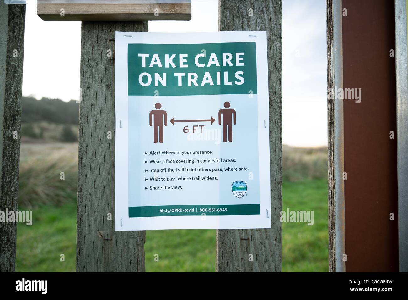 Segno di istruzione di allontanamento sociale su palo di legno in Oregon Foto Stock