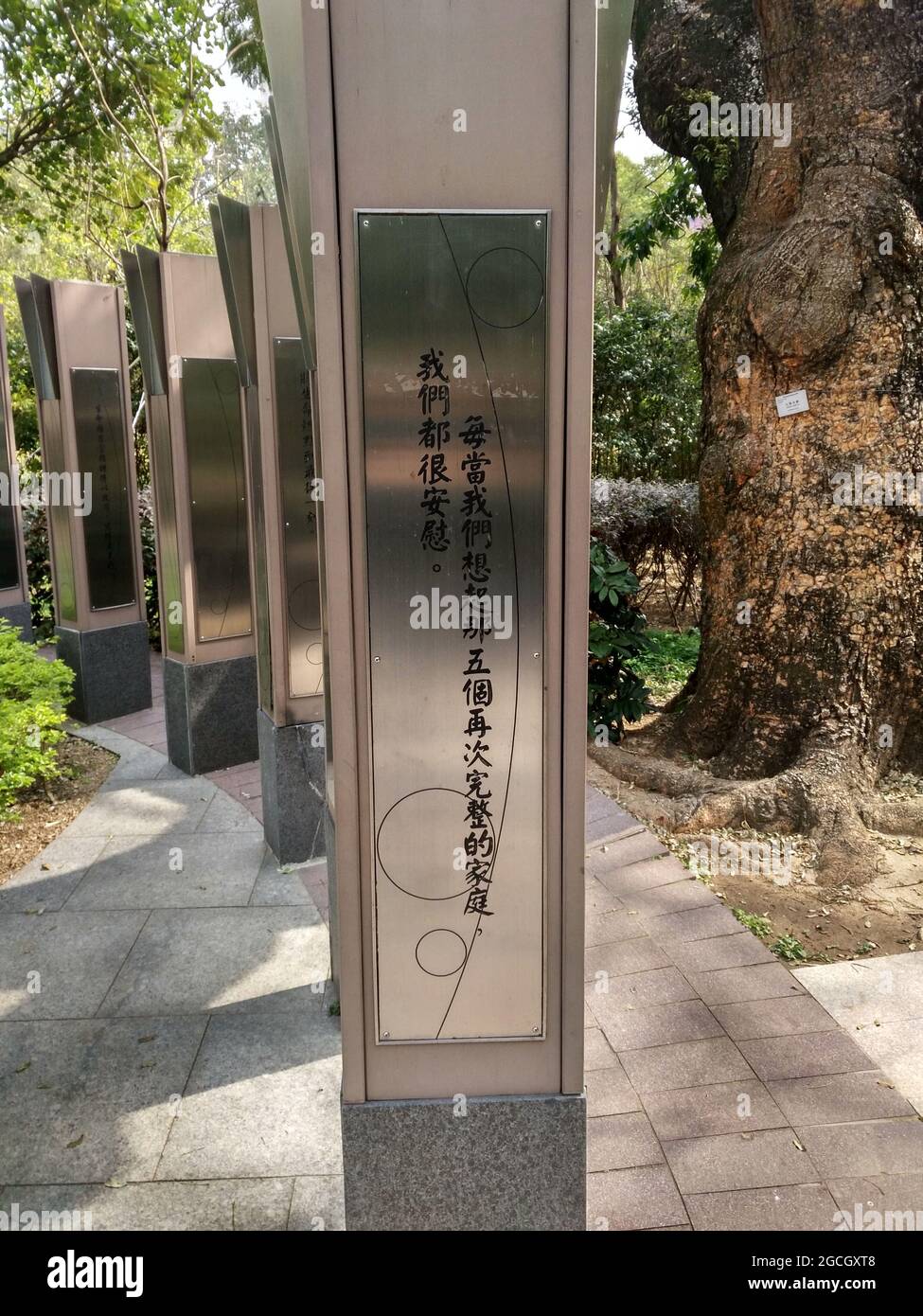 Una bella mostra d'arte moderna nel Kowloon Park di Hong Kong con placche di metallo coperte di scrittura cinese Foto Stock