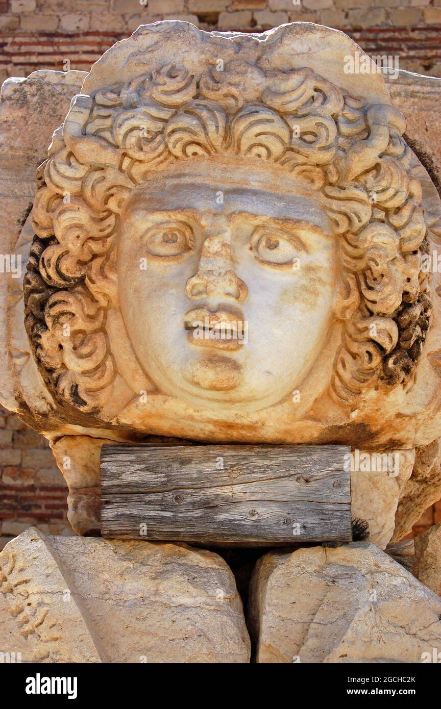 Antica scultura romana del volto di Medussa nelle rovine del Foro Severan a Leptis Magna, Libia. Foto Stock