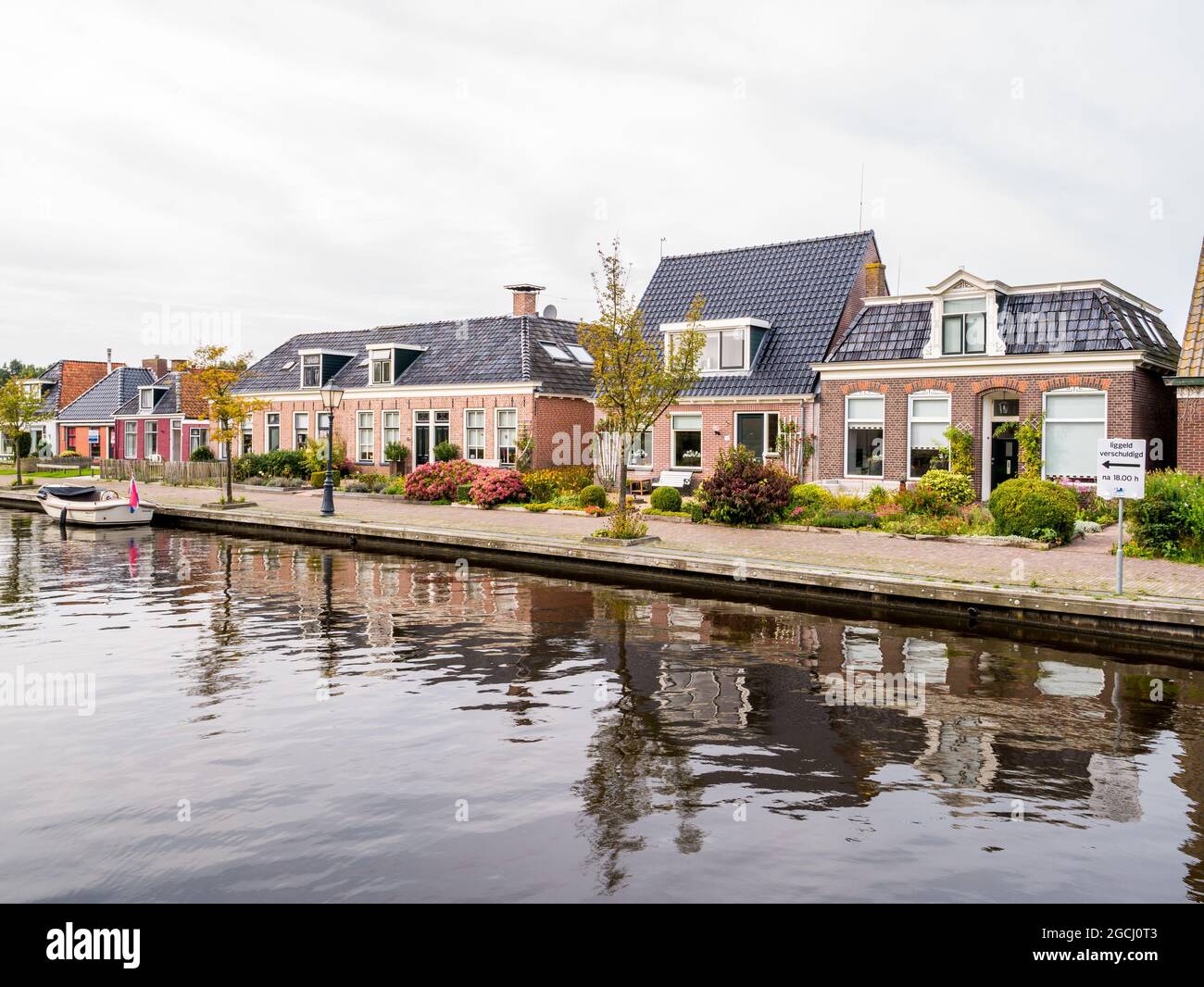 Case di canale nel vecchio villaggio di Wartena, Leeuwarden, Friesland, Paesi Bassi Foto Stock