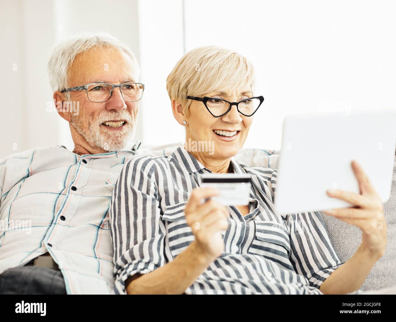 coppia anziana tavoletta felice insieme uomo donna shopping carta di credito acquisto ordine acquisto online pagamento Foto Stock