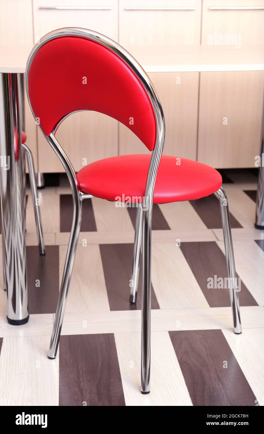 Moderne sedie rosse vicino a tavola in cucina Foto stock - Alamy