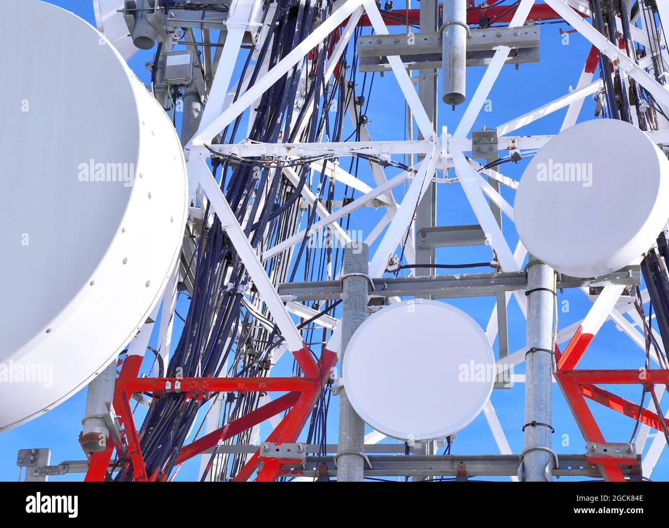 Basso angolo della moderna torre radio con molte antenne rotonde situate  contro il cielo blu Foto stock - Alamy