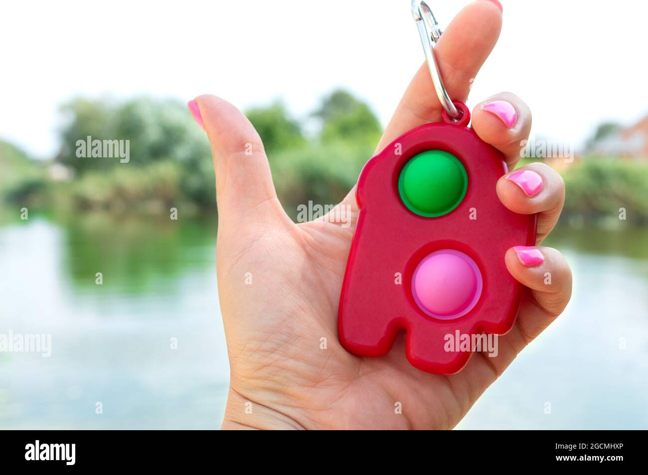 Concavità semplice - giocattolo a trinket in gomma colorato antistress in mano. Primo piano. Foto Stock
