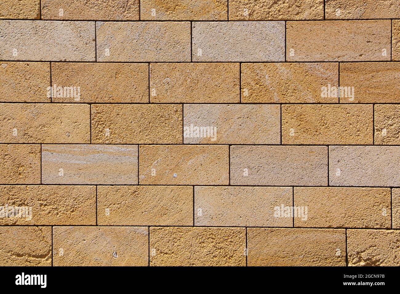 muro di mattoni di arenaria, sfondo, primo piano. Struttura ecocompatibile Foto Stock