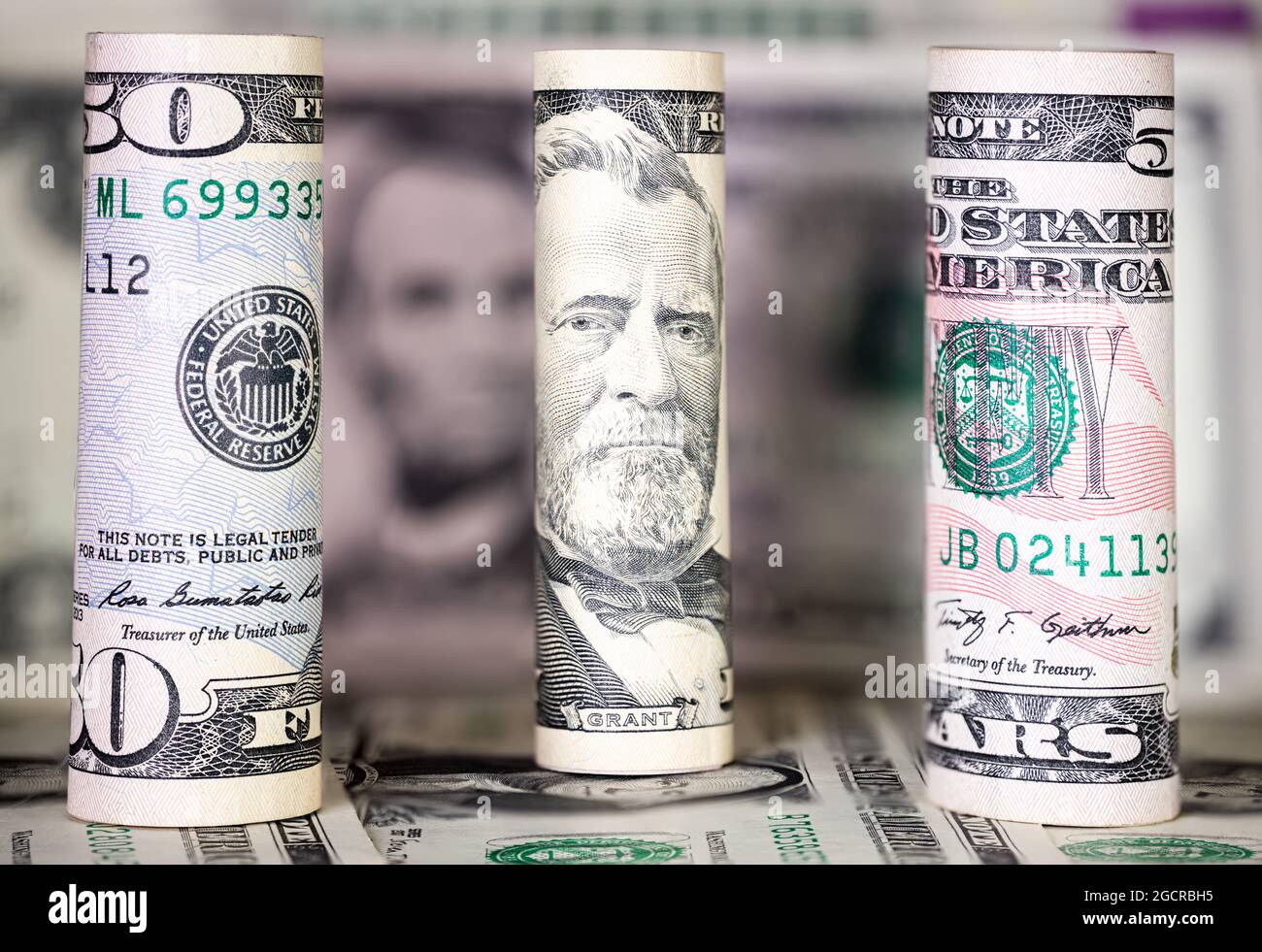 Primo piano fino a 50 dollari USA . Macrofotografia delle banconote americane rotolate. In background, un'ulteriore nomina del denaro statunitense. Il ritratto sul 5 Foto Stock
