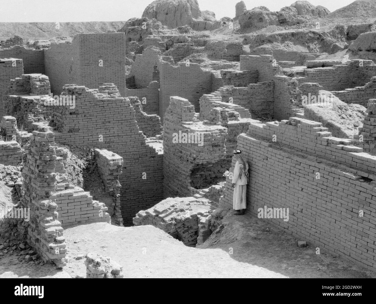 1930 Iraq - Babilonia il grande. Uomo in piedi tra le rovine sminuzzanti di Babilonia ca. 1932 Foto Stock