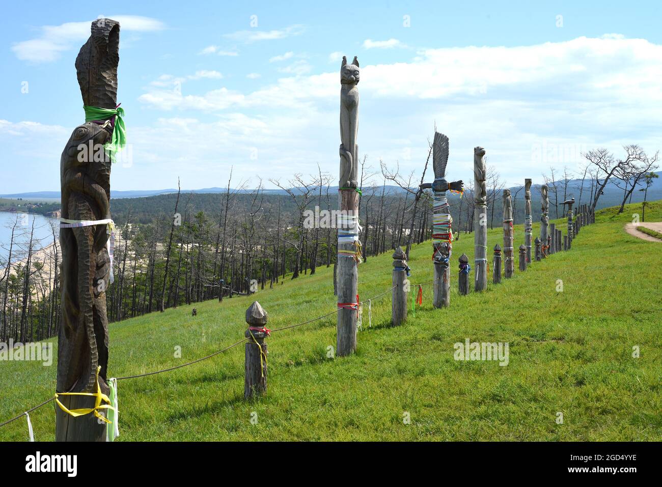 Olkhon, oblast di Irkutsk, Russia - 23 Luglio 2021:Fence fatto di pali di aggancio in legno con nastri di religione sciamanista a Khuzhir, isola di Olkhon. Foto Stock