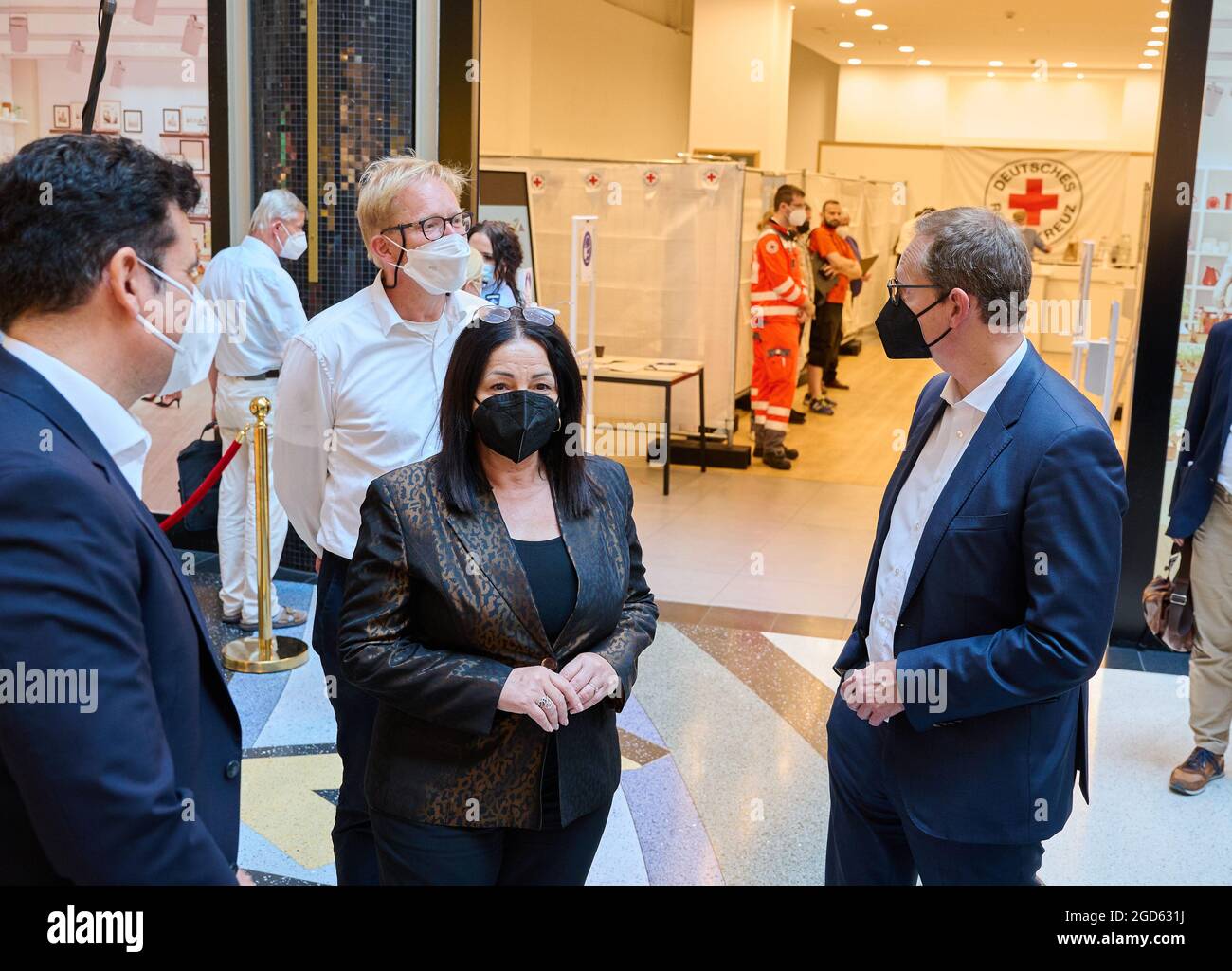 11 agosto 2021, Berlino: Oliver Hanna (l-r), Center Manager del centro commerciale Alexa, Ephraim Gothe (SPD), Consigliere Distrettuale per lo sviluppo Urbano, Dilek Kalayci (SPD), Senatore per la Salute, e Michael Müller (SPD), Sindaco di Berlino, si trovano di fronte al nuovo centro vaccinazioni nel centro commerciale Alexa. Dal lunedì al sabato tra le 10:00 e le 17:00, i visitatori hanno la possibilità di vaccinarsi direttamente in loco. Nel centro di vaccinazione pop-up nel centro commerciale, i vaccini di Johnson&Johnson e moderna sono vaccinati. Foto: Annette Riedl/dpa Foto Stock