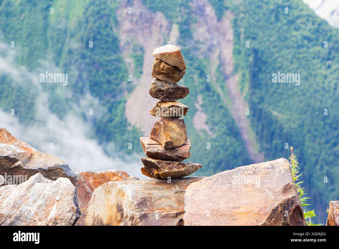 Pietre equilibrate sullo sfondo di montagne, equilibrio e tranquillità. Foto Stock