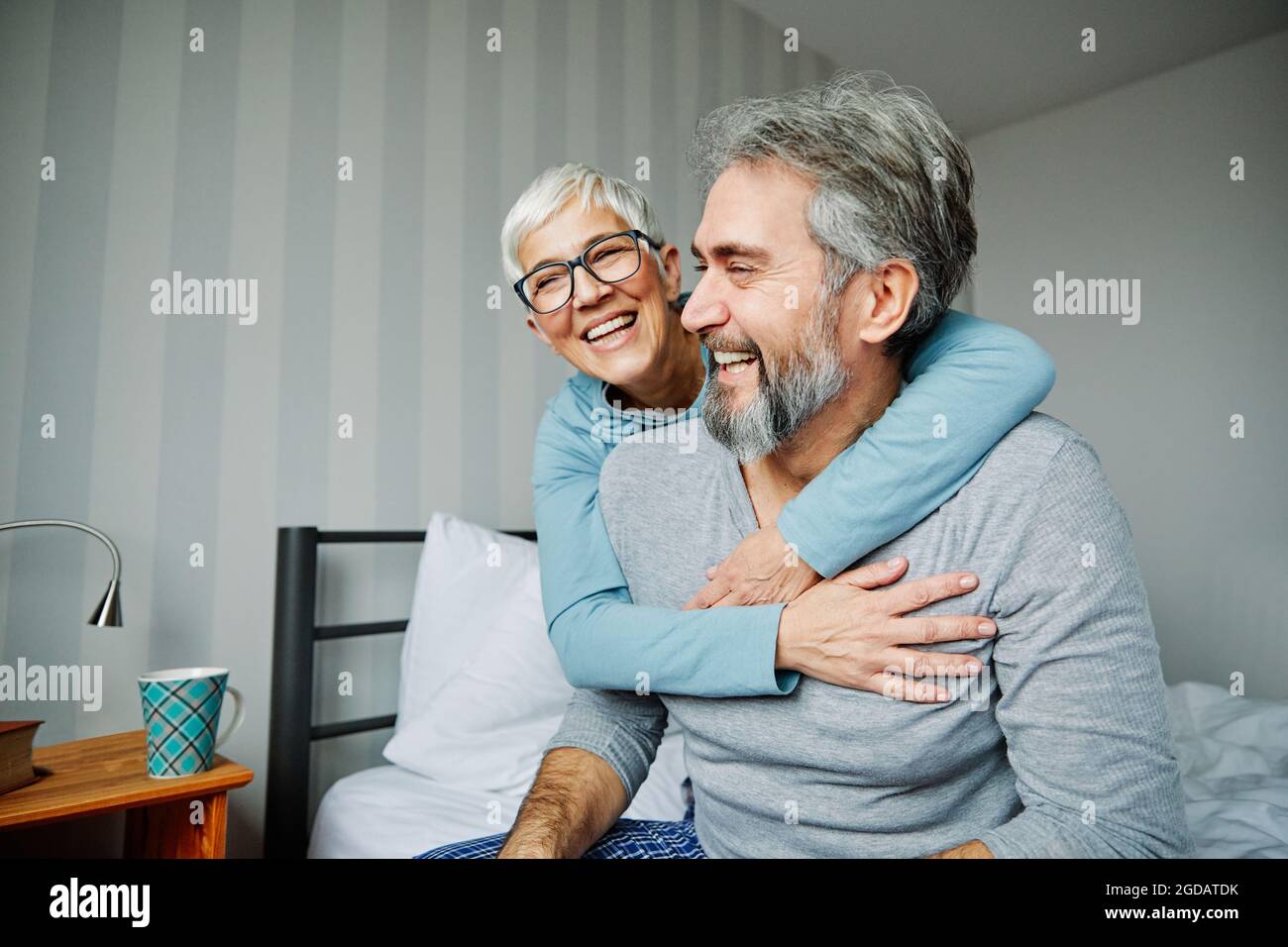 il coulle senior si trova a letto e si diverte a ridere Foto Stock