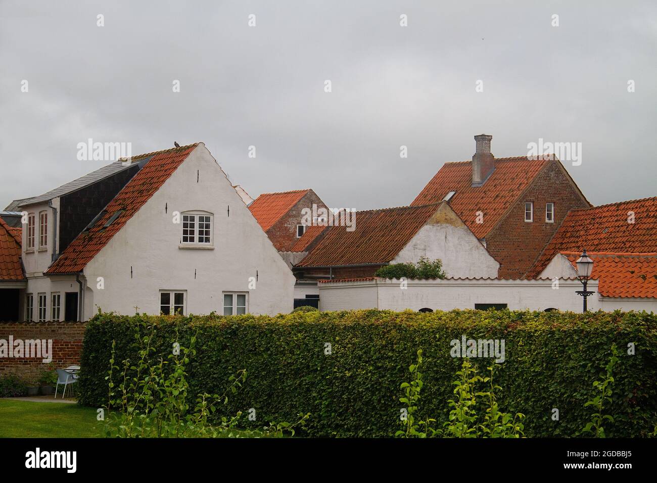 Vista dal retro su case bianche e tetti di tegole rosse a Ribe, Danimarca Foto Stock