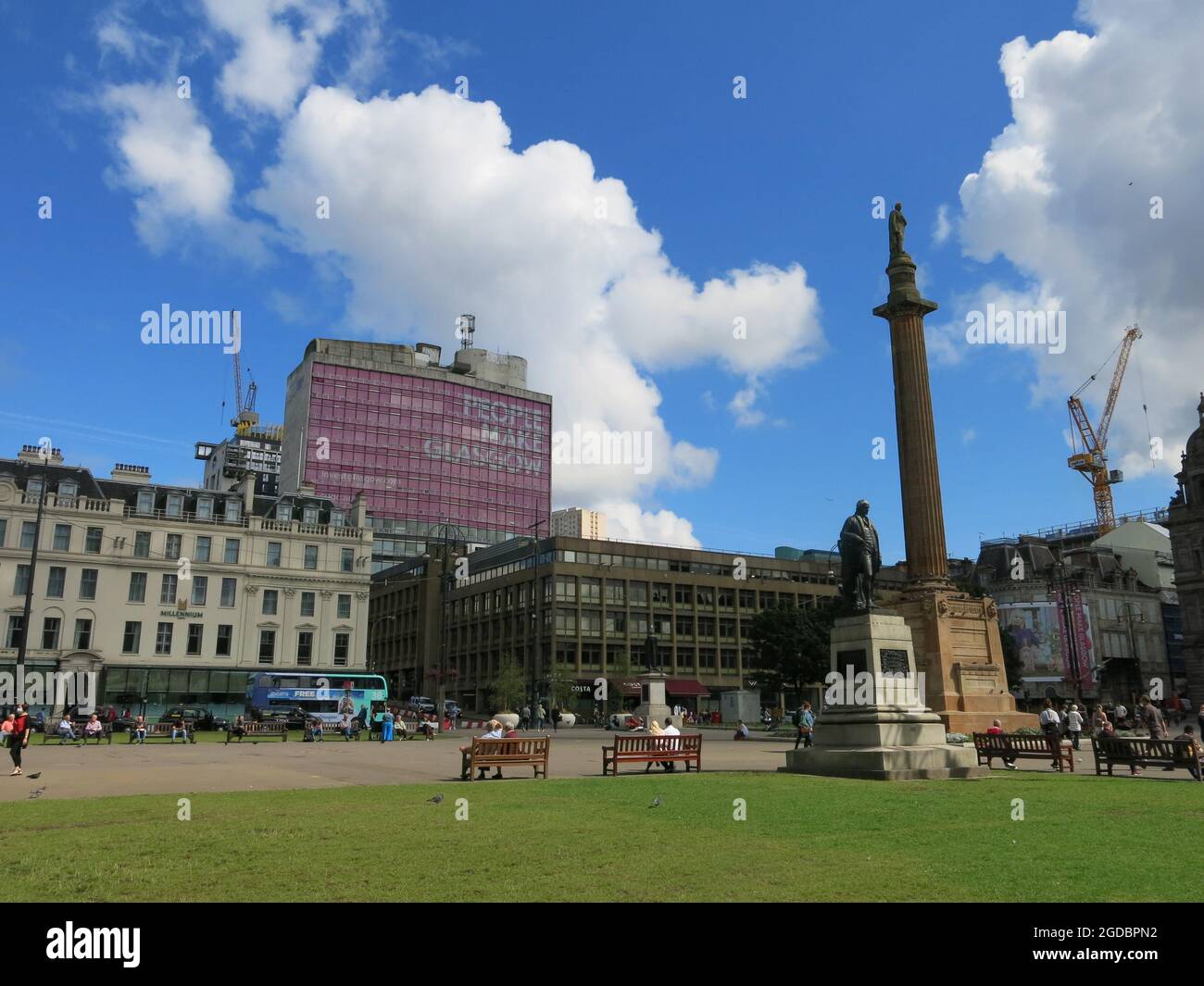 Vista di George Square con il Monumento Scott e il popolare slogan "People Make Glasgow" nelle finestre di un edificio adiacente. Foto Stock