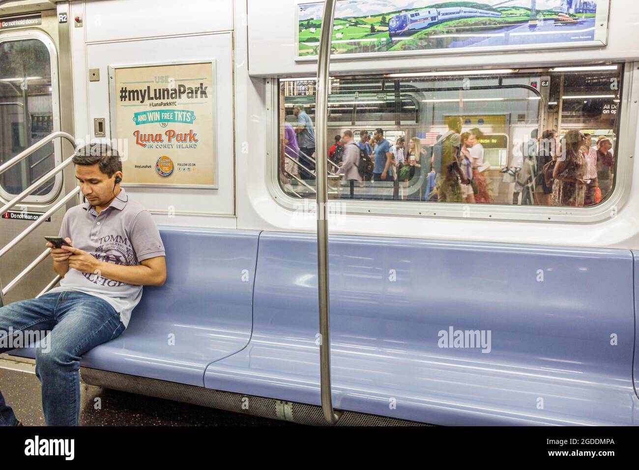 NY,NYC,New York City,Lower Manhattan Subway,MTA IRT Lexington Avenue linea fermata stazione Asian uomo maschio,smartphone cellulare controllo cercando lettura t Foto Stock