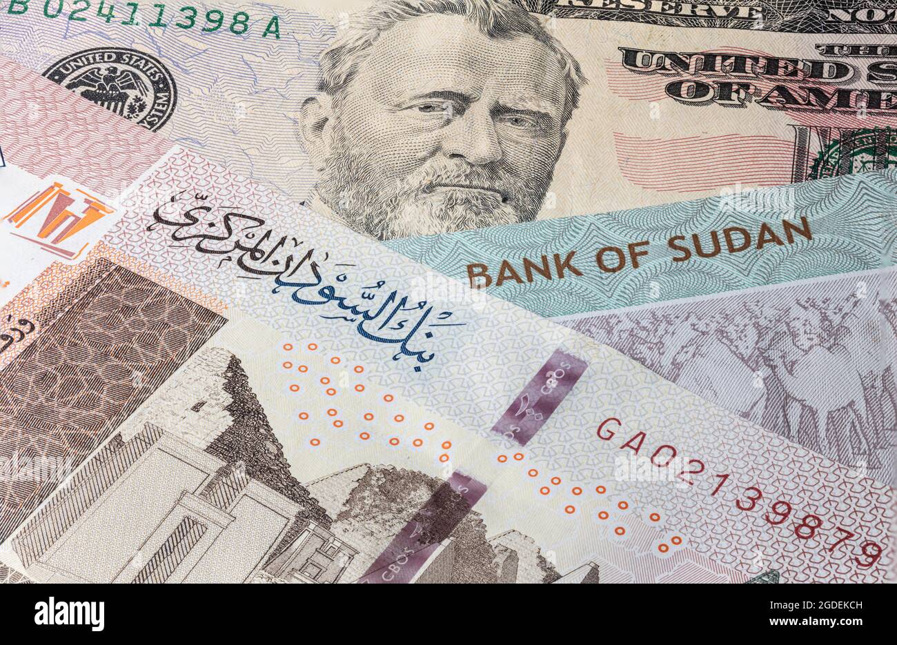 Primo piano fino a 100 libbre sudanesi della Repubblica Sudan accanto alle banconote in dollari USA. 100 banconote in sterline del paese africano Sudan. Denaro US con sud Foto Stock