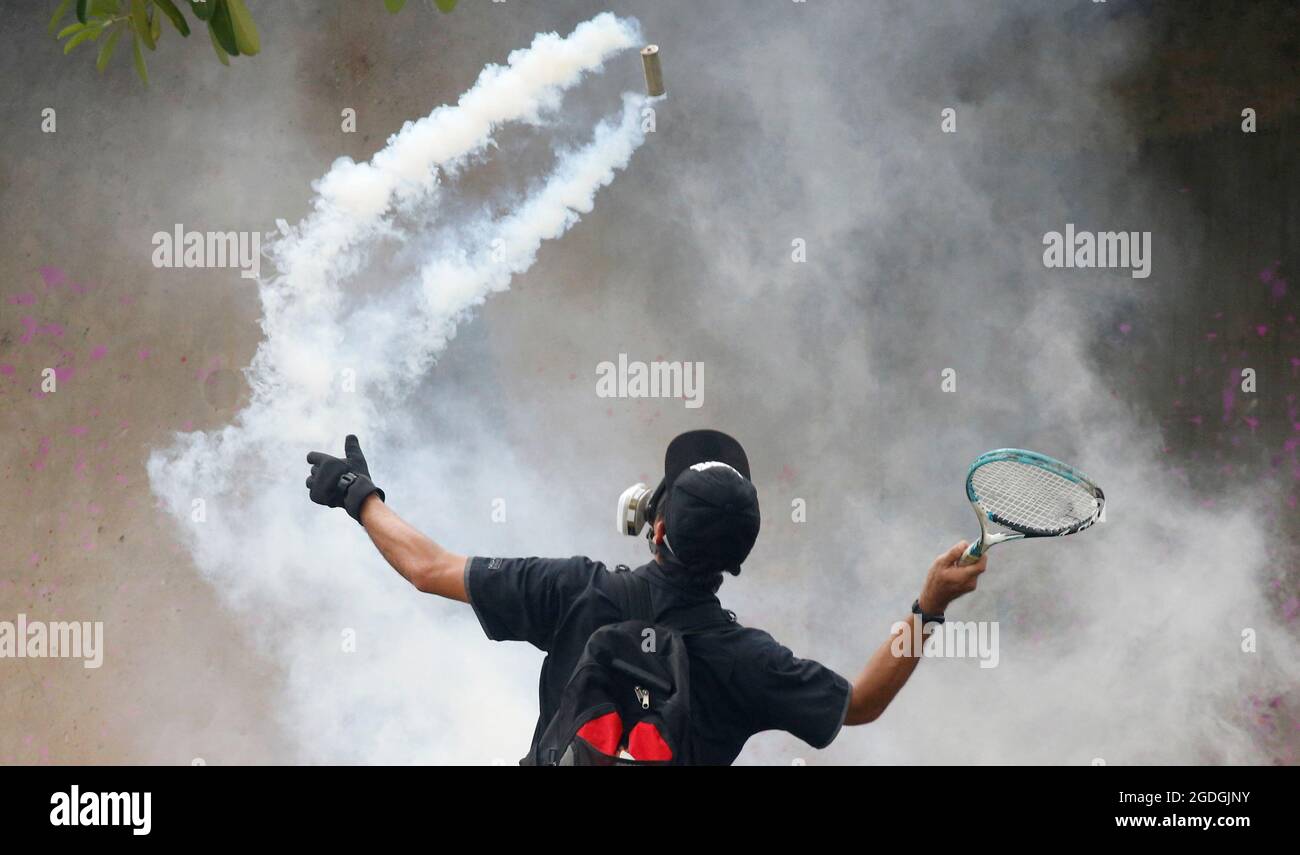 Un dimostratore usa una racchetta contro un barattolo di gas lacrimogeno durante una protesta per la gestione da parte del governo della malattia di coronavirus (COVID-19) pandemia, a Bangkok, Thailandia 13 agosto 2021. REUTERS/Soe Zeya Tun Foto Stock