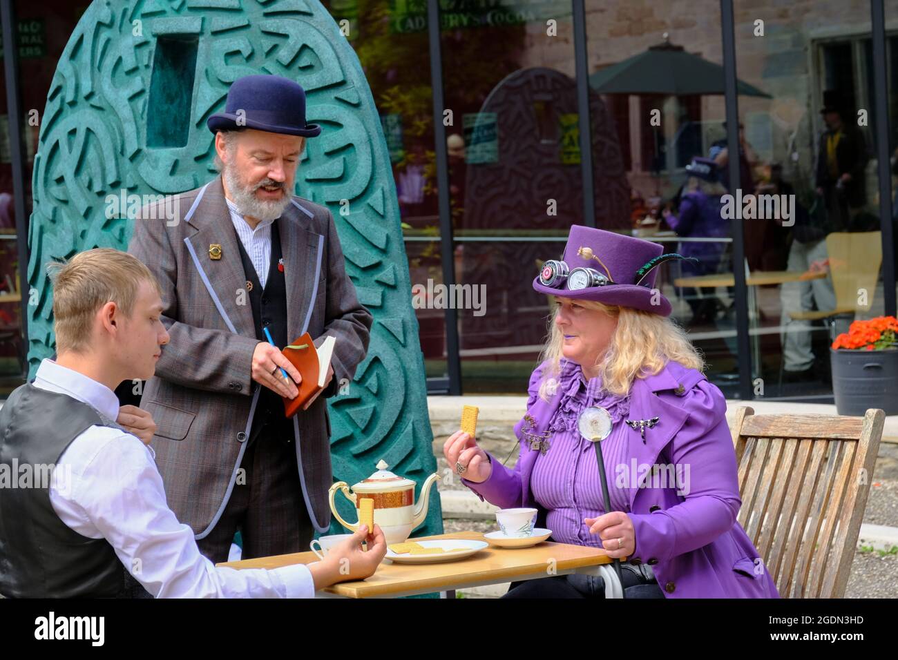 Stroud, Glos, Regno Unito. 14 agosto 2021. Tutte le cose Steampunk sono celebrate oggi a Stratford Park e il Museo nel Parco di Stroud. Steampunk è un genere fantascientifico con le sue radici in H G Wells e Jules Verne, caratterizzato dalla moda vittoriana e il desiderio di fuggire in un passato che non è ancora successo. Nella foto è raffigurato un duello di tè, che si dunking con la minaccia. Credit: JMF News/Alamy Live News Foto Stock