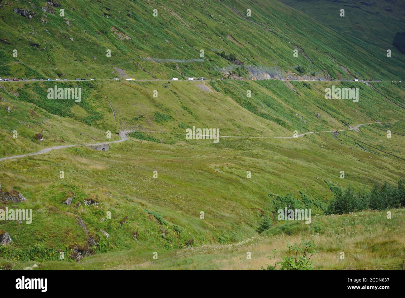 Traffico lento catturato in lavori stradali sulla A83 sopra General Wade's Old Military Road, Glen Croe, Argyll e Bute, Scozia, Regno Unito. Foto Stock