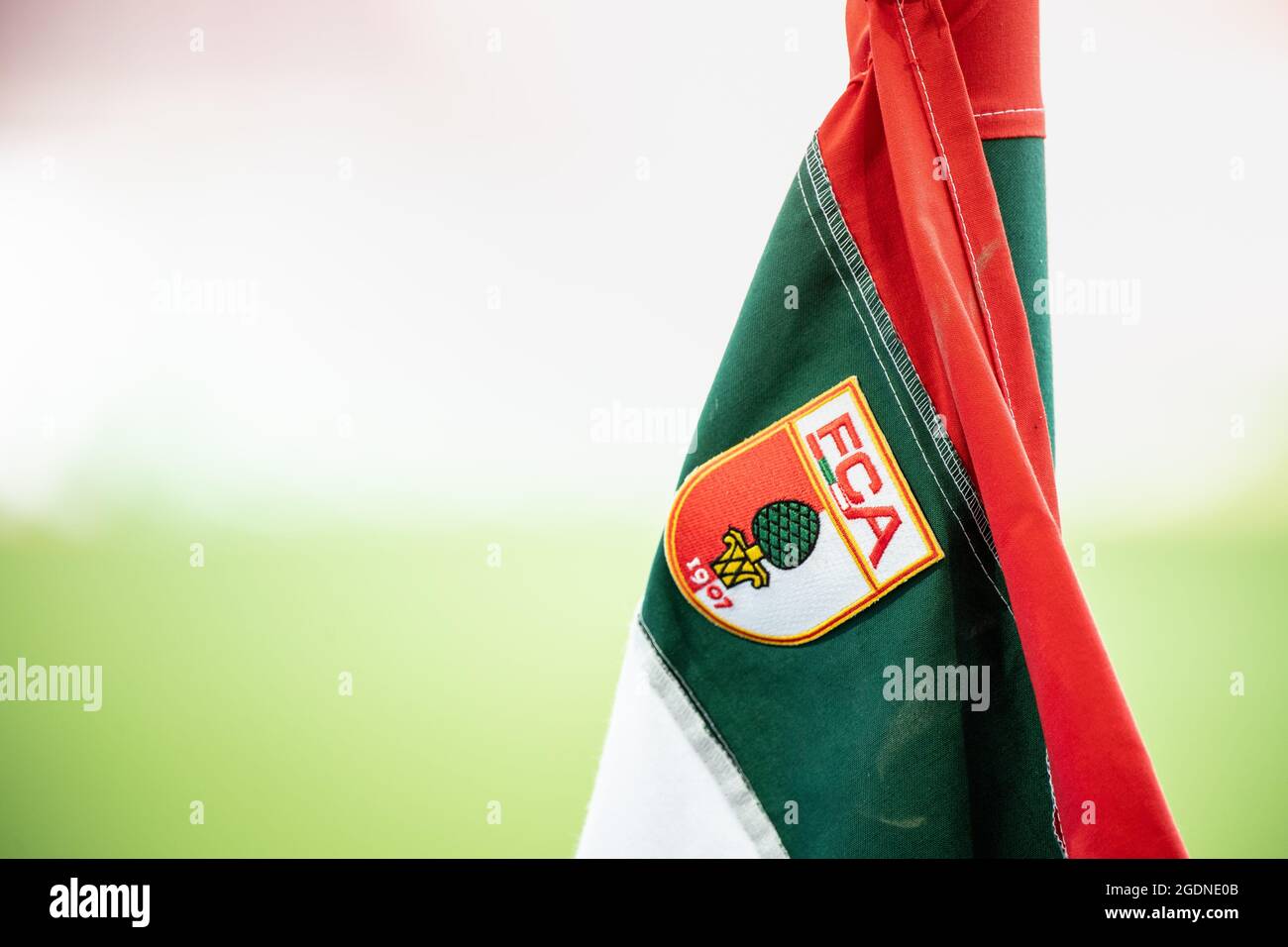 Augusta, Germania. 14 agosto 2021. Calcio: Bundesliga, FC Augusta - TSG 1899 Hoffenheim, Matchday 1 alla WWK Arena. Il logo del club del FC Augusta, uno stemma con l'iscrizione FCA e l'immagine di una pineta, è visibile su una bandiera d'angolo dello stadio. Credito: Matthias Balk/dpa - NOTA IMPORTANTE: In conformità con le norme del DFL Deutsche Fußball Liga e/o del DFB Deutscher Fußball-Bund, è vietato utilizzare o utilizzare fotografie scattate nello stadio e/o della partita sotto forma di sequenze fotografiche e/o serie fotografiche di tipo video./dpa/Alamy Live News Foto Stock