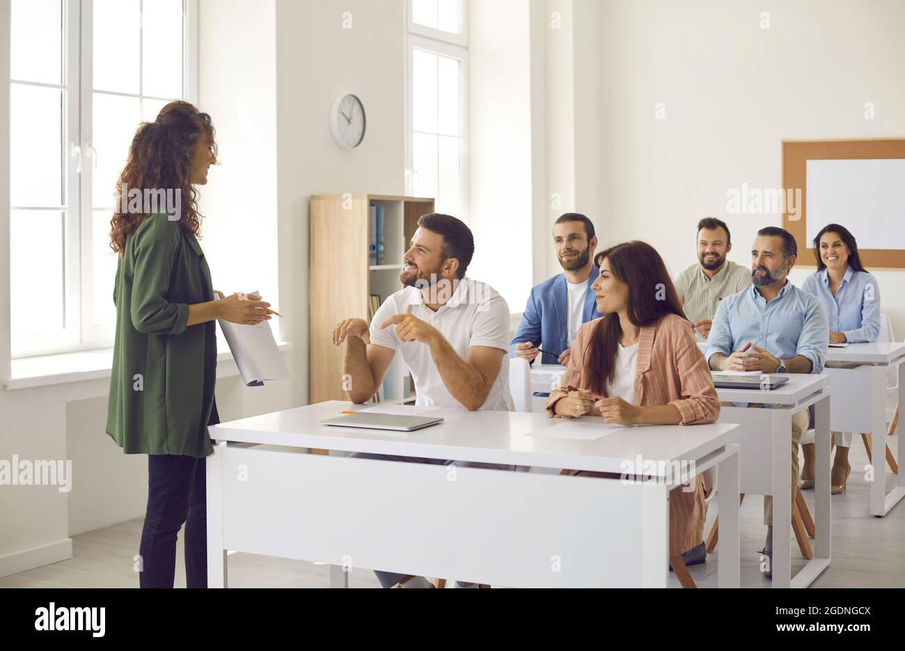 Gruppo di studenti adulti che hanno una discussione durante la lezione con l'insegnante di università di affari Foto Stock