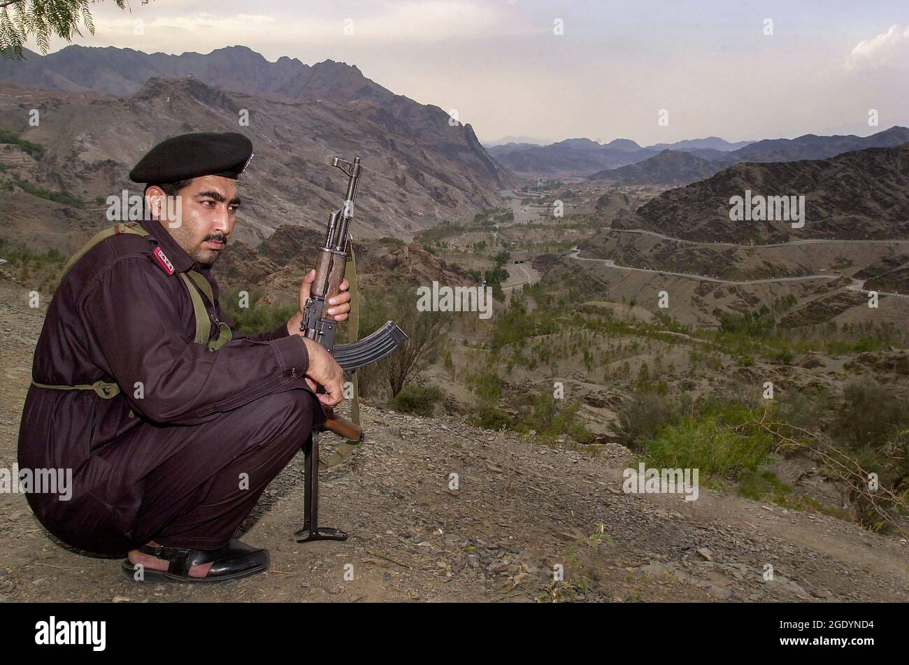 Torkham Pakistan. Un soldato dei Khyber Rifles custodisce l'estremità nord del Passo Khyber con il confine Pakistan/Afghanistan a Torkham nella valle sottostante. Foto Stock