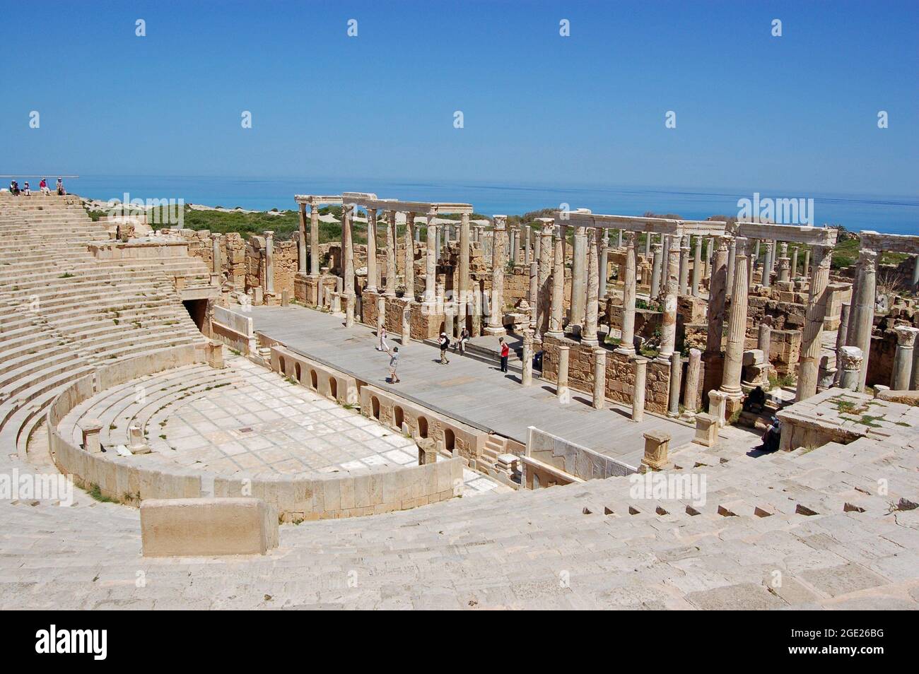 Leptis Magna, Libia - 2 aprile 2006: I turisti esplorano l'antico teatro romano che si affaccia sul Mar Mediterraneo sulla costa libica. Foto Stock