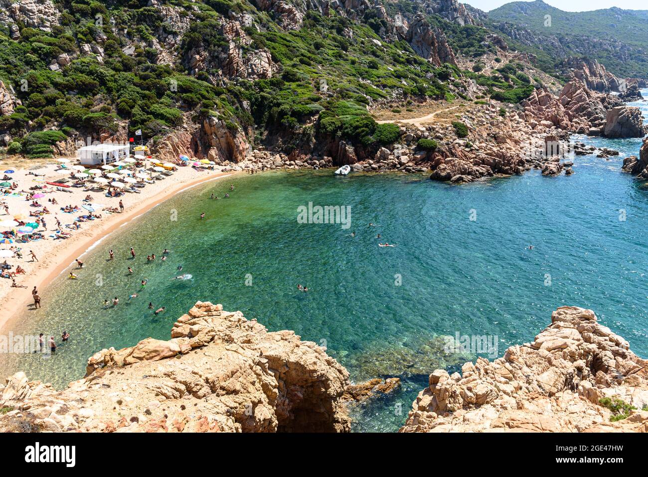 Persone e ombrelloni / ombrelloni sulla spiaggia di li Cossi alla Costa Paradiso di Sardegna, Italia Foto Stock