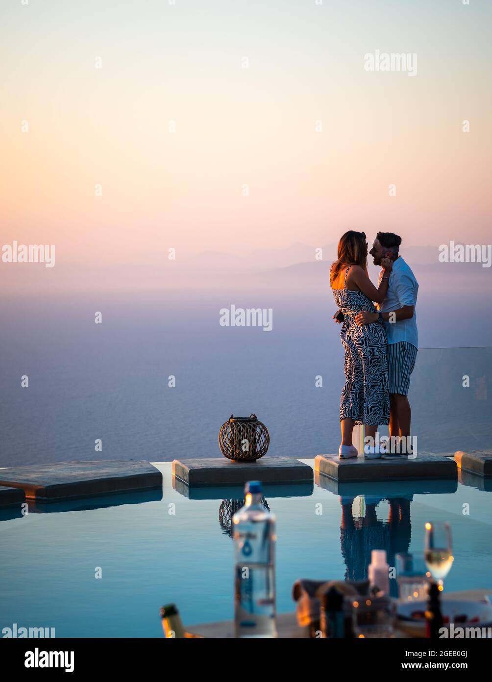 Isola di Lefkada. Grecia- 08.07.2021: Una giovane coppia che gode di romanticismo e di una bella cena a lato della piscina con una fantastica vista sul mare. Foto Stock