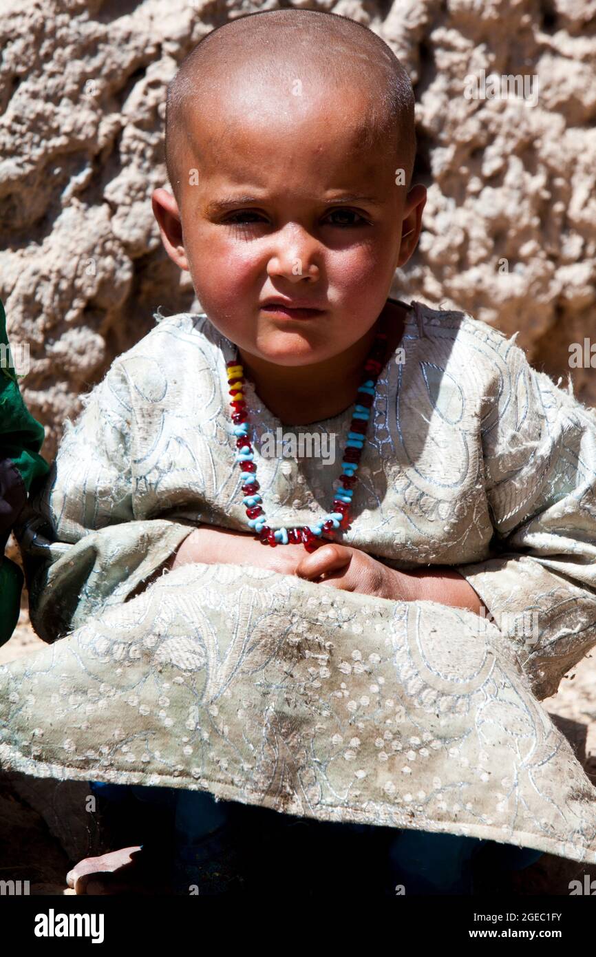 BASE DI PATTUGLIA FULOD, provincia di Helmand, Repubblica Islamica dell'Afghanistan - Seaman Orlando C. Farase, corpsman del Team Advisor 4 annesso alla Società C, 1° Battaglione, 5° reggimento marino, bende la mano di un bambino mentre è in pattuglia a Sangin, Afghanistan, maggio 11. I soldati dell'esercito nazionale afghano del 2° Tolay, il 2° Kandak, guidarono la pattuglia di presenza attraverso Sangin e furono accompagnati da consulenti marini per la squadra che era strettamente lì per osservare i soldati dell'ANA e offrire un feedback. Farase, 22 anni, è di Pensacola, Fla. Foto Stock