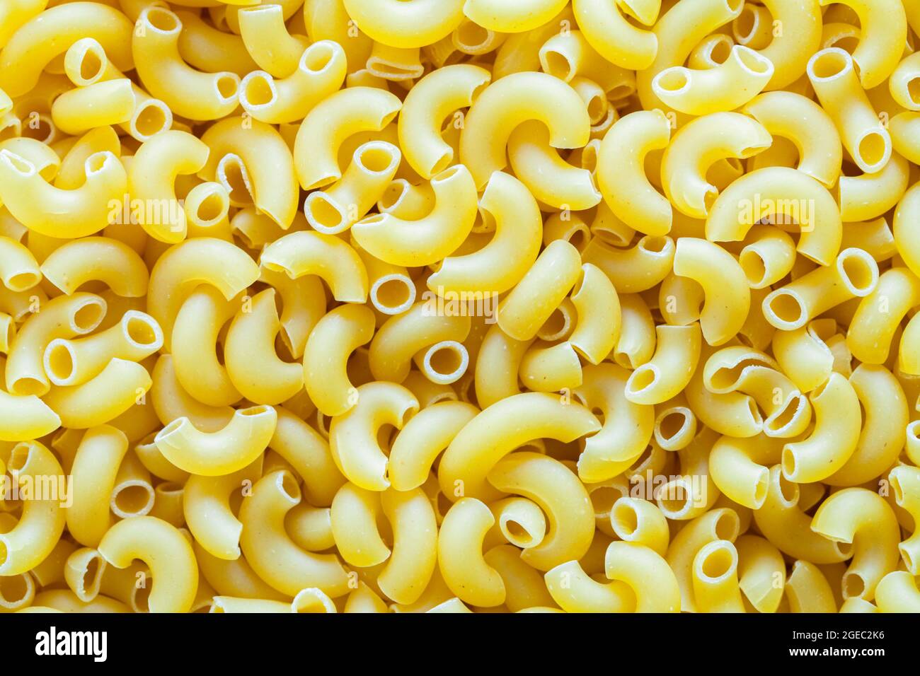 Dry Macoroni Noodle Pasta Pasta Pile di fondo Texture. Foto Stock