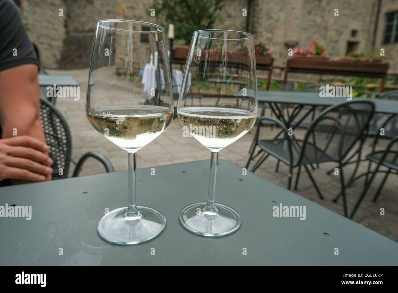 due bicchieri di vino bianco nel ristorante sui tavoli dall'altra parte esterna del ristorante. Terrazza del ristorante. Foto Stock