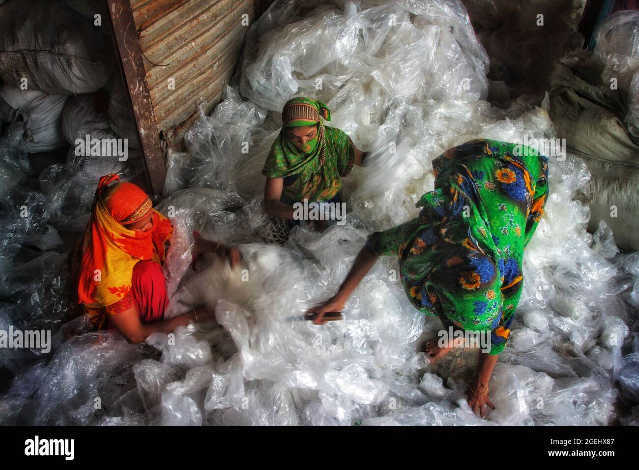 Dhaka, Bangladesh . 20 ago 2021. Dhaka, Bangladesh, 20 agosto 2021: Le lavoratrici di Kagrangichar raccolgono e separano i sacchi monouso da riutilizzare in una fabbrica di politene. Credit: Maruf Rahman /Eyepix Group/Alamy Live News Credit: Eyepix Group/Alamy Live News Foto Stock