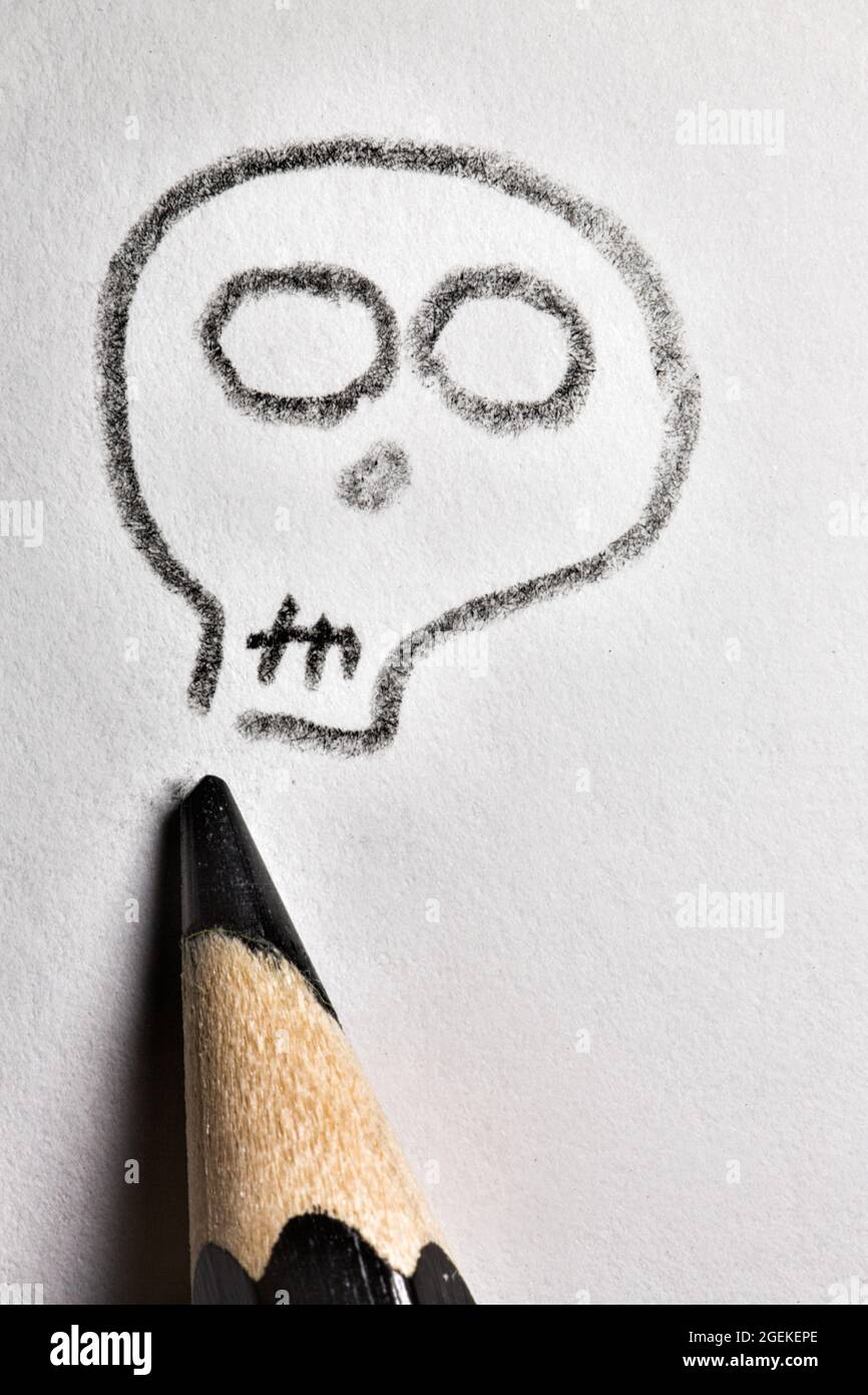 Vista ad angolo alto della matita nera e del cranio disegnato. Foto Stock