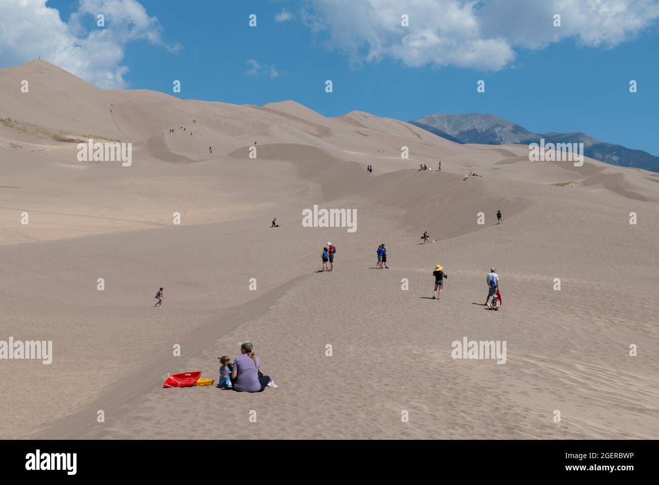 Colorado, San Luis Valley, Great Sand Dunes National Park. Grandi dune di sabbia alte fino a 750 metri. Turisti che si godono le dune. Foto Stock