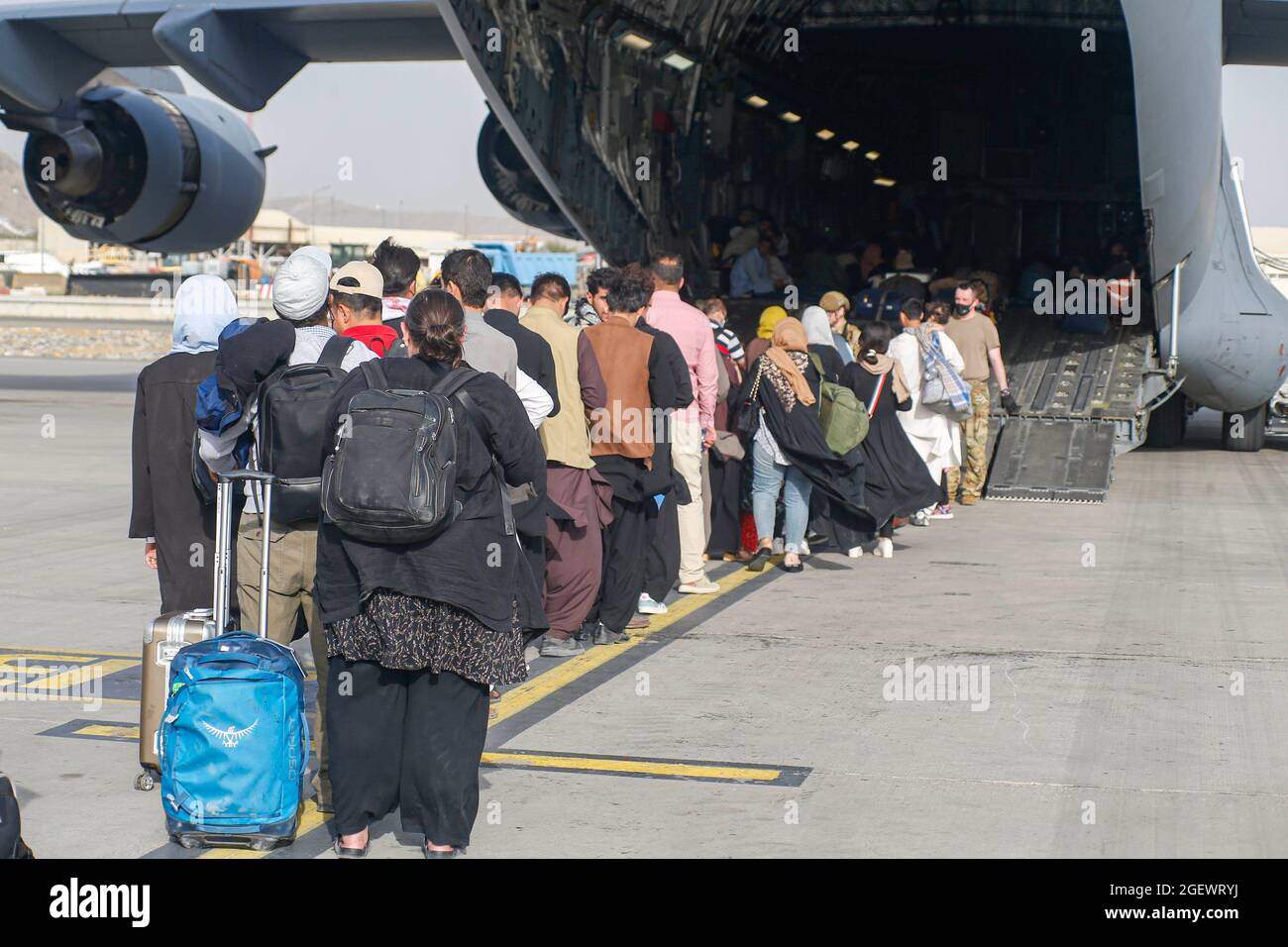 Gli evacuati si fanno tappa prima di salire a bordo di un C-17 Globemaster III durante un'evacuazione all'aeroporto internazionale Hamid Karzai, Afghanistan, 18 agosto 2021. I membri del servizio USA stanno assistendo il Dipartimento di Stato degli Stati Uniti con un prelievo ordinato di personale designato in Afghanistan. Credito obbligatorio: Nicholas Guevara/US Marine Corps via CNP /MediaPunch Foto Stock