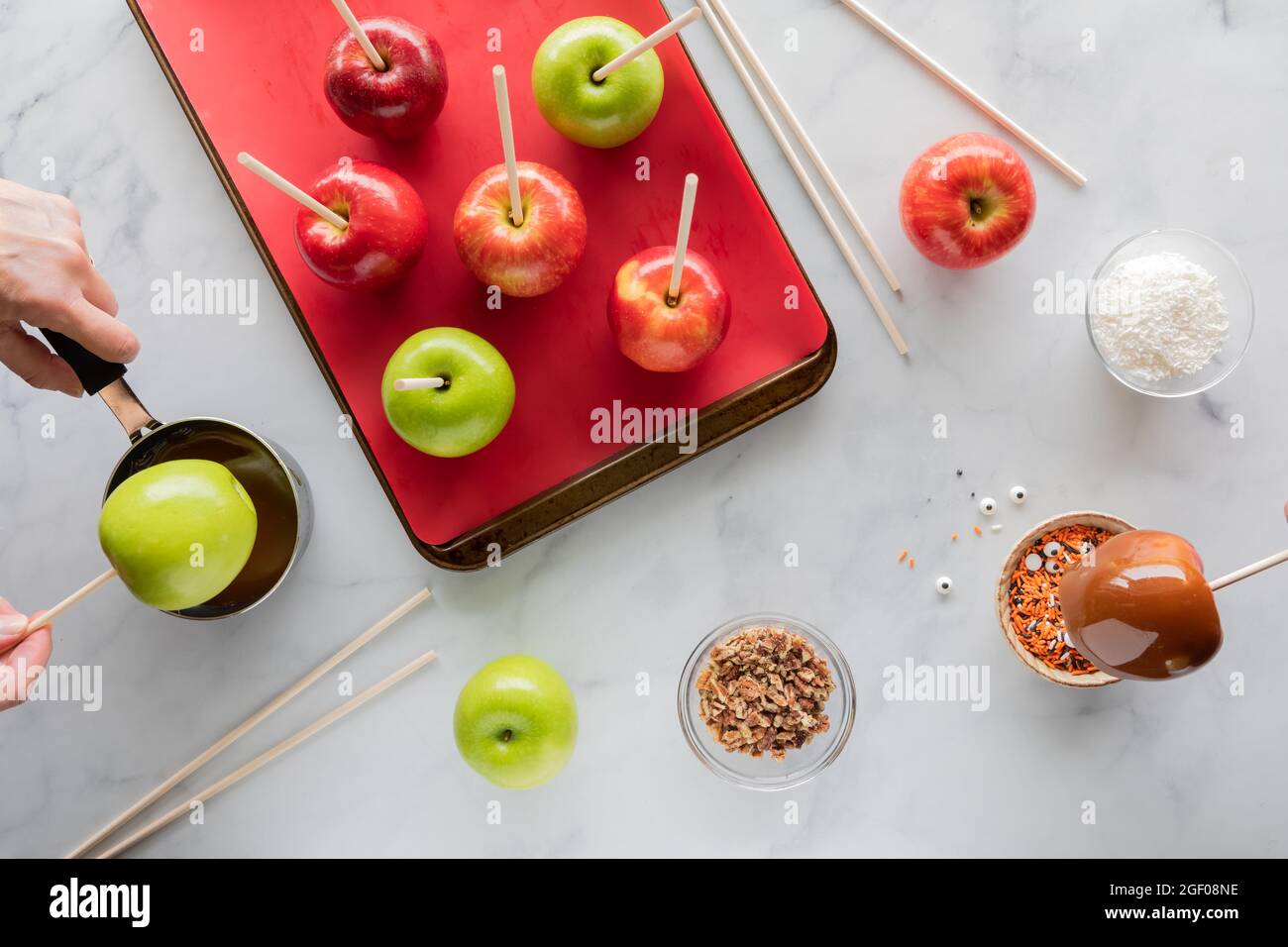 Vista dall'alto verso il basso delle mele preparate per preparare le mele al caramello di Halloween. Foto Stock