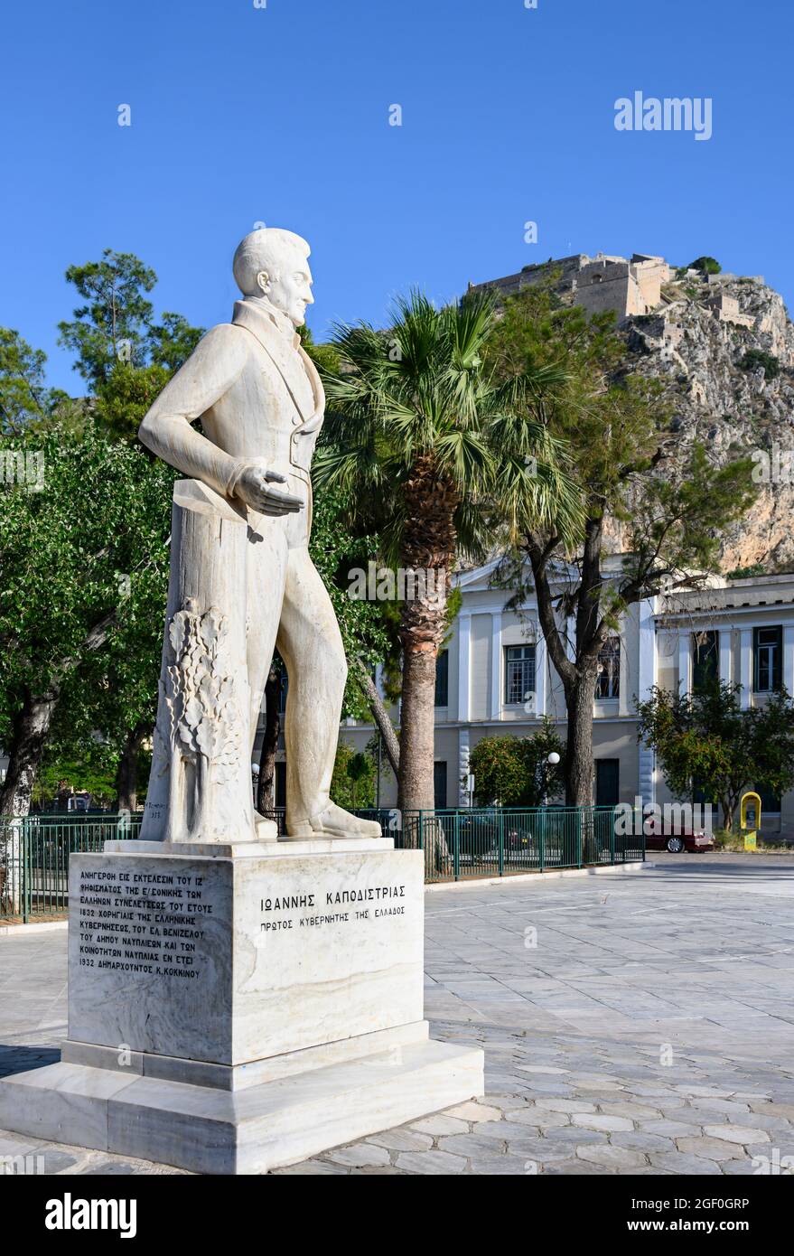 Una statua di Ioannis Kapodistrias, il primo capo di stato della Grecia indipendente, con la fortezza Palamidhi, sullo sfondo, Nafplio, Argolid, P. Foto Stock