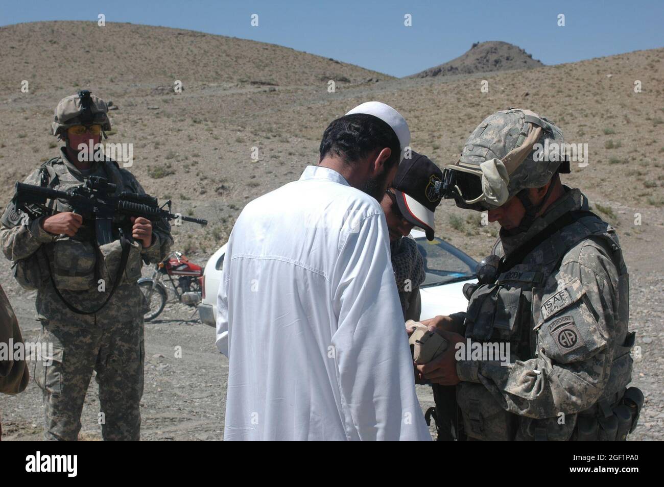 PFC. Bryan Sarge, (a sinistra), medic di combattimento, quartier generale e sede centrale Troop, 4 ° Squadron, 73rd Cavalry Regiment, 4 ° Brigade Combat Team, 82nd Airborne Divison, fornisce la sicurezza, mentre PFC. Joseph Moody, un fantino con HHT mette in discussione la gente del posto durante una fermata di controllo di traffico 04 giugno 2007 nel distretto di Andar della provincia di Ghazni, Afghanistan. Foto dell'esercito degli Stati Uniti di Sgt. Matthew Clifton (rilasciato) Foto Stock