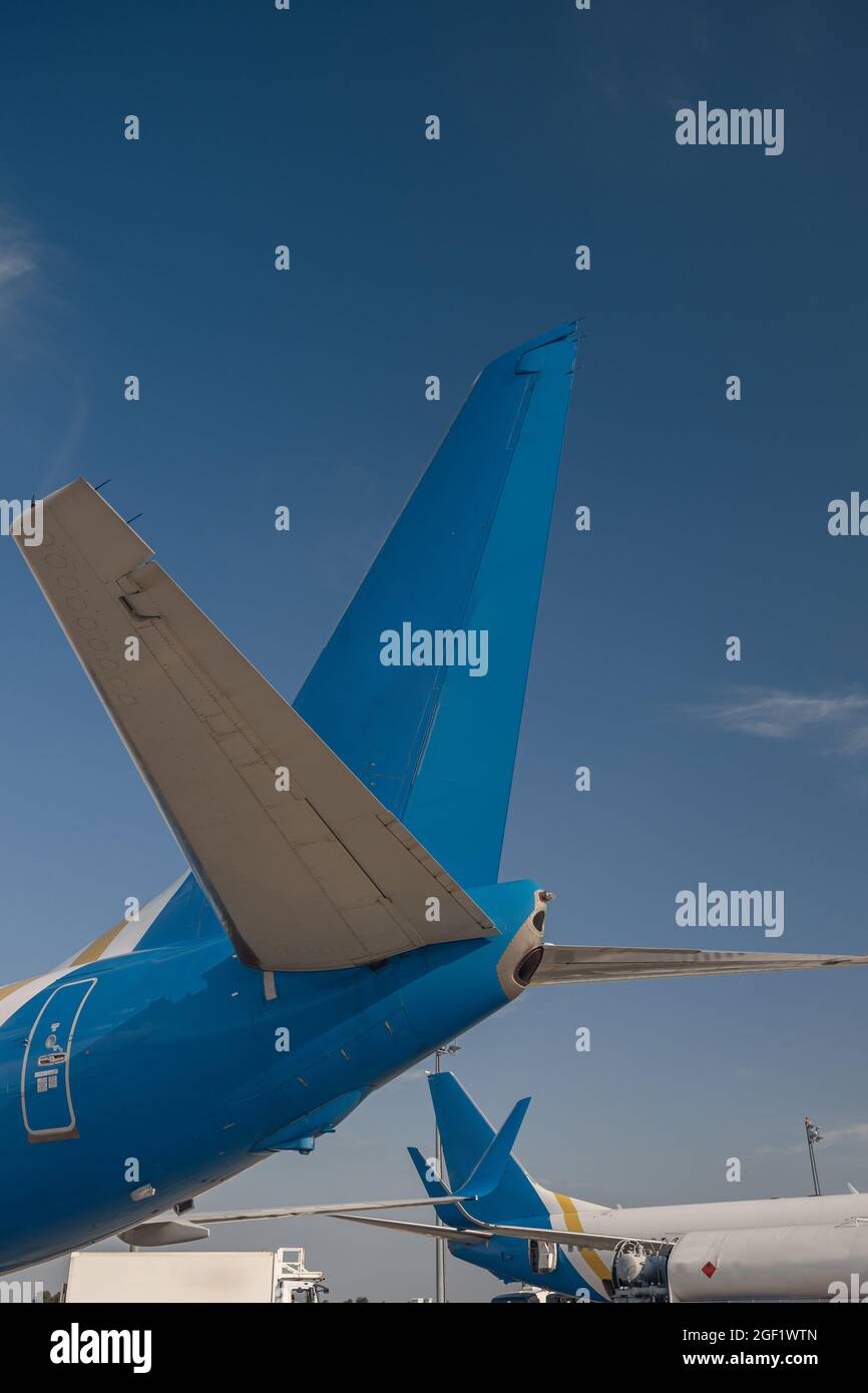 Coda di aerei di compagnie aeree internazionali in aeroporto con cielo blu sullo sfondo Foto Stock