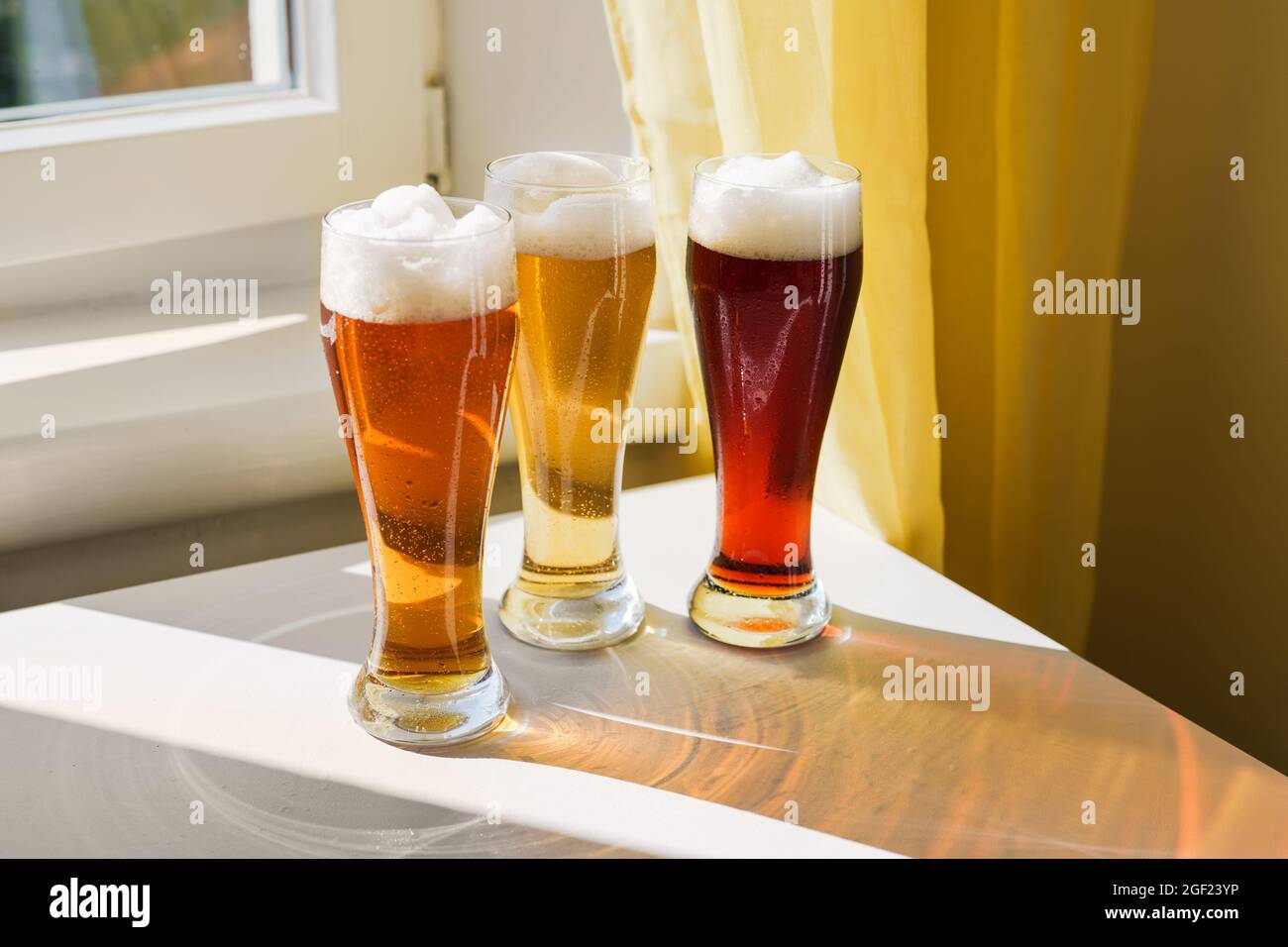 Tre bicchieri con diversi tipi di birra sul tavolo Foto Stock